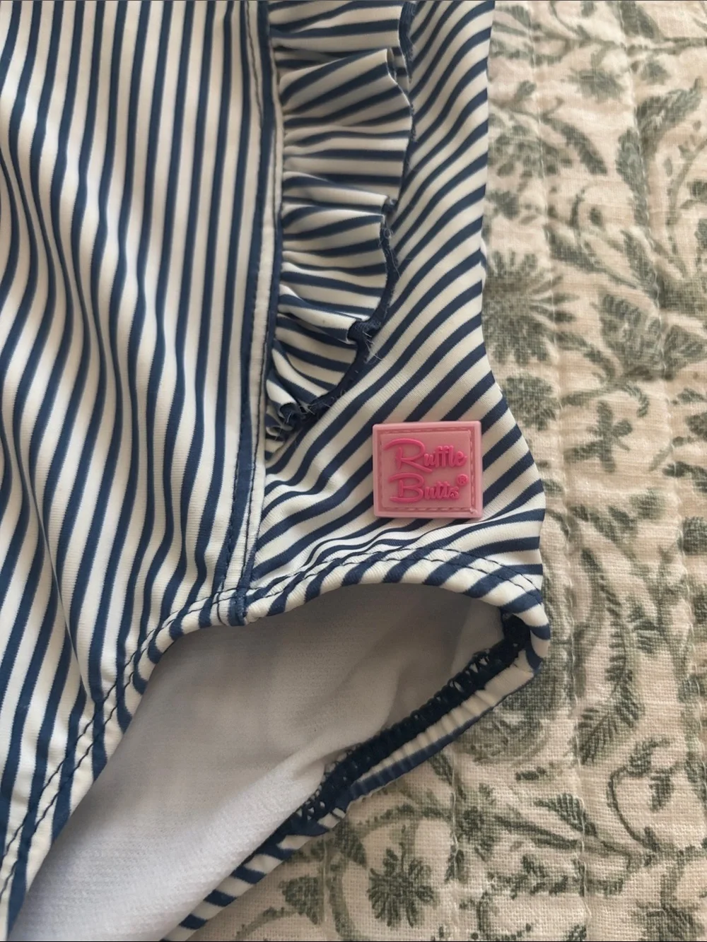Ruffle Butts Navy and White Striped Ruffle One-Piece with Pink Logo
